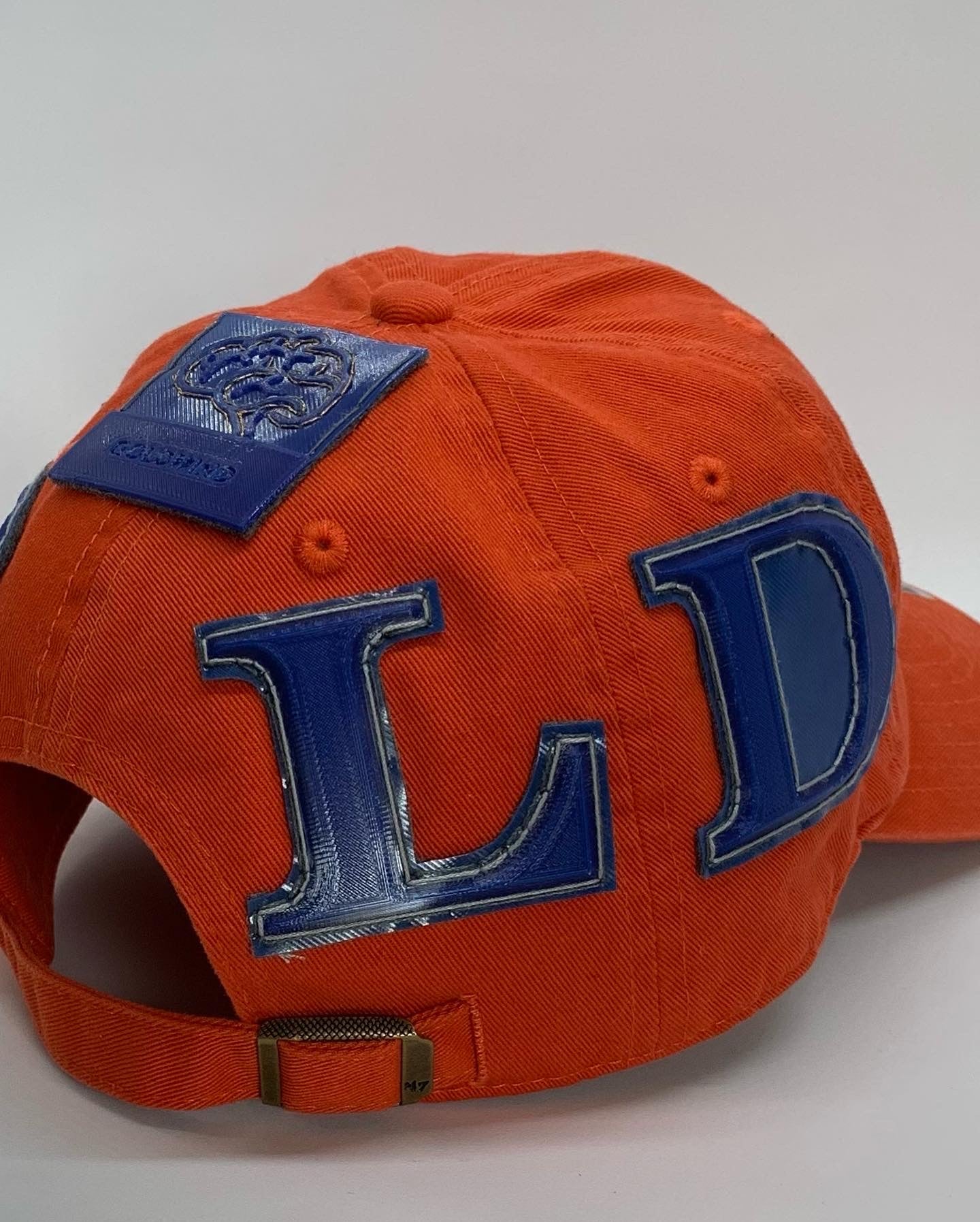 Front in the Back GOLD dad hat in orange and blue